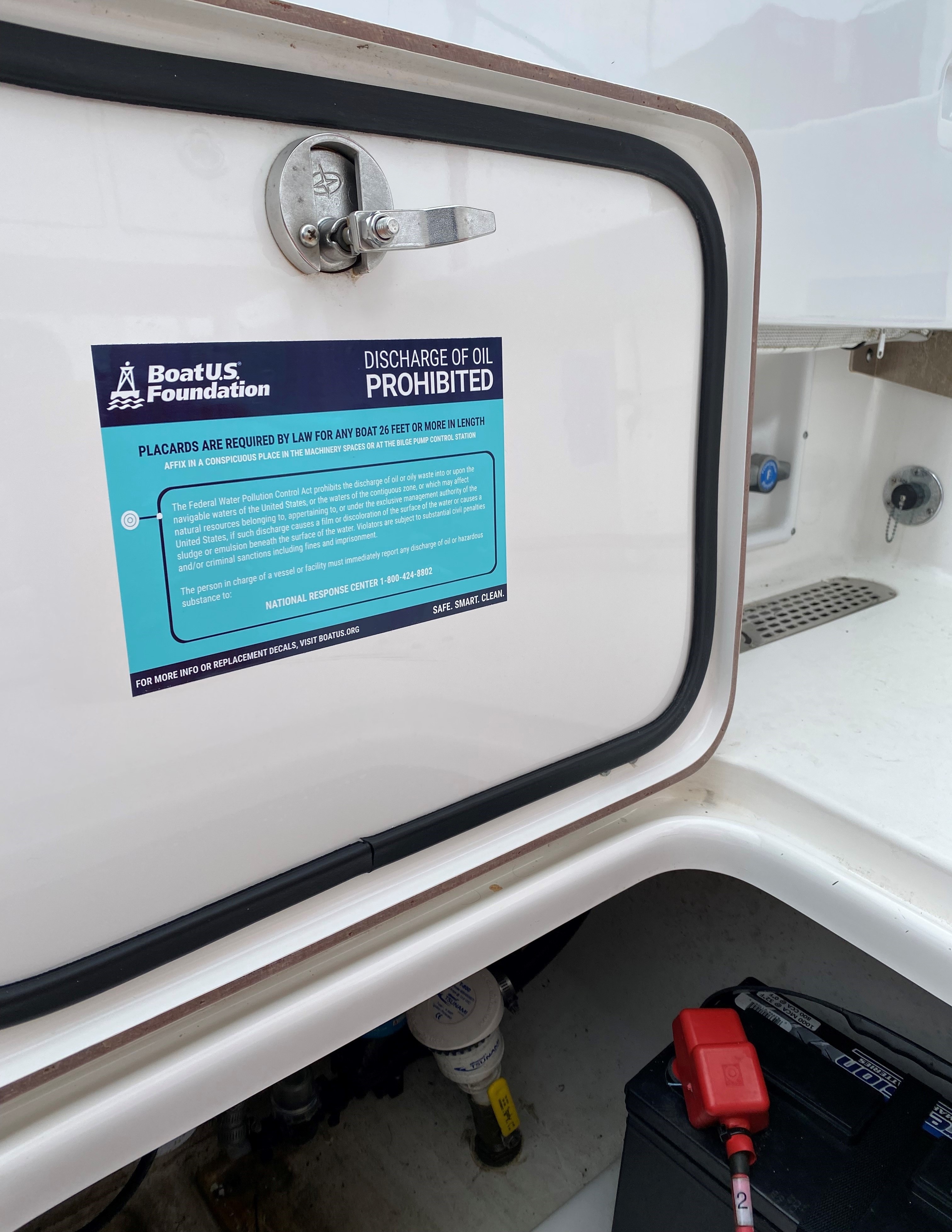 The BoatUS Foundation oil discharge placard decal on machinery spaces, such as a bilge access door, helps ensure proper handling of oil waste.  